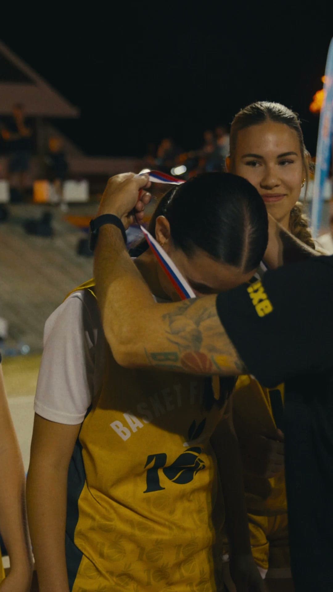 Medal ceremony embrace at camp